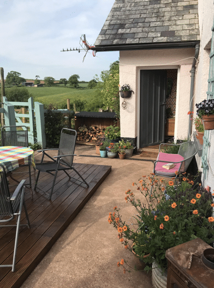 fully renovated outdoors with raised decking and garden furniture