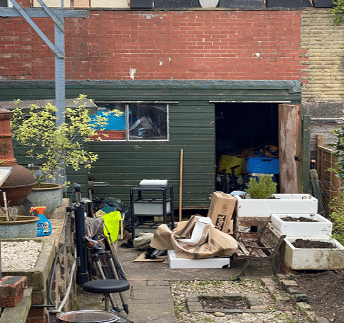 messy garden shed with clutter outside