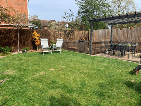 garden lawn with deck chairs and pergola seated area
