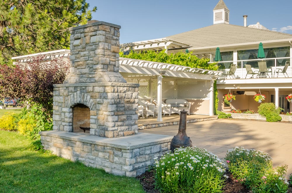 grey brick bbq with chimney and gazebo in background