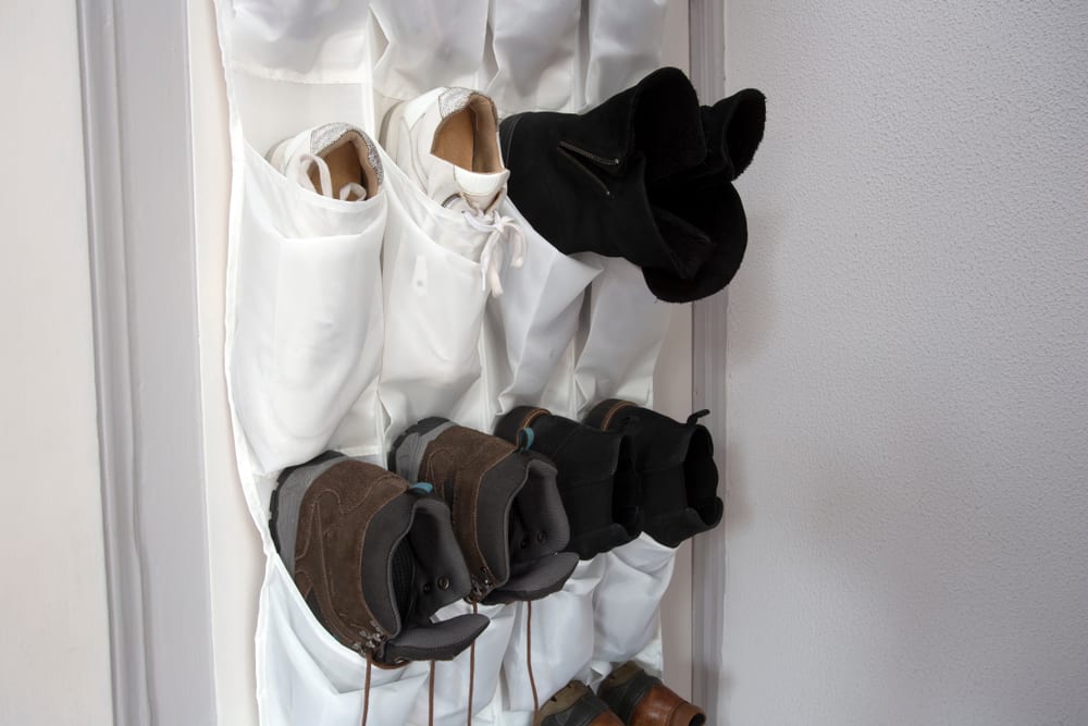 shoes hanging in a white shoe rack