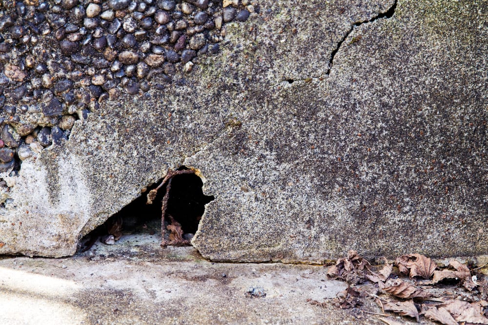 a hole under a concrete step